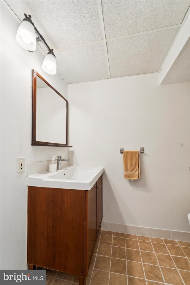 bathroom with tile patterned floors and vanity