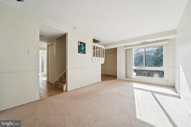 empty room featuring light colored carpet