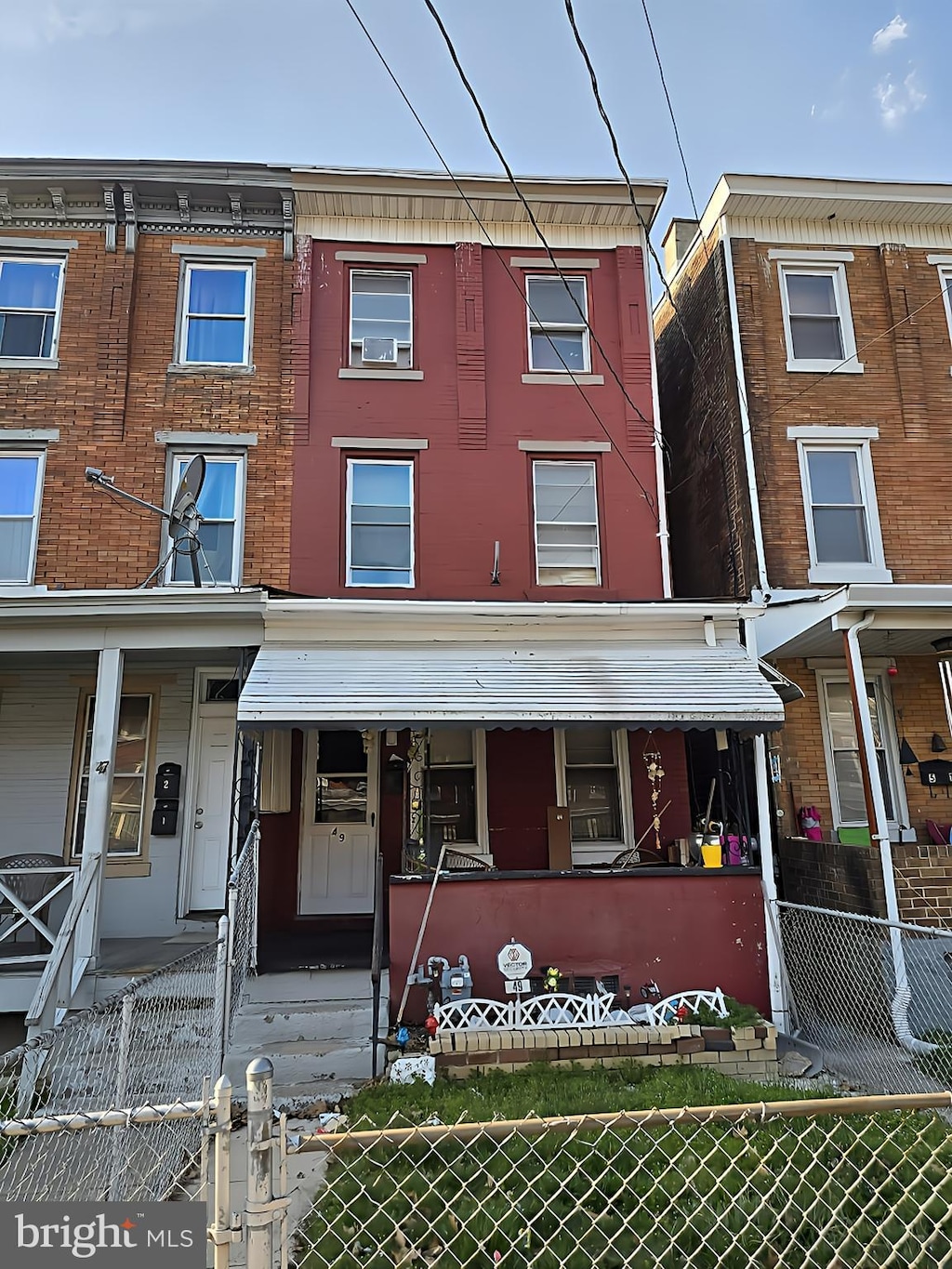 multi unit property with a gate and a fenced front yard