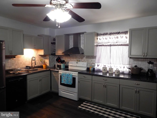 kitchen with a sink, black appliances, gray cabinets, and wall chimney range hood