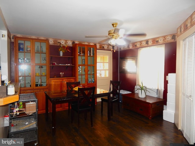 dining space featuring dark wood-type flooring and ceiling fan