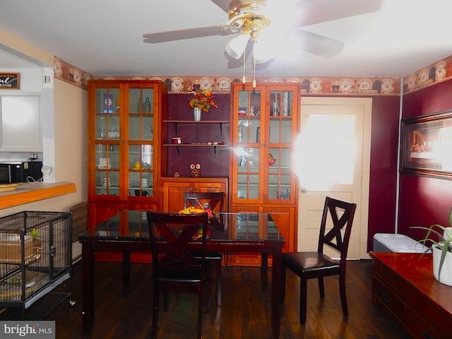 dining room with a ceiling fan and wood finished floors