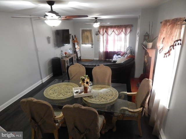 dining room with baseboards and wood finished floors