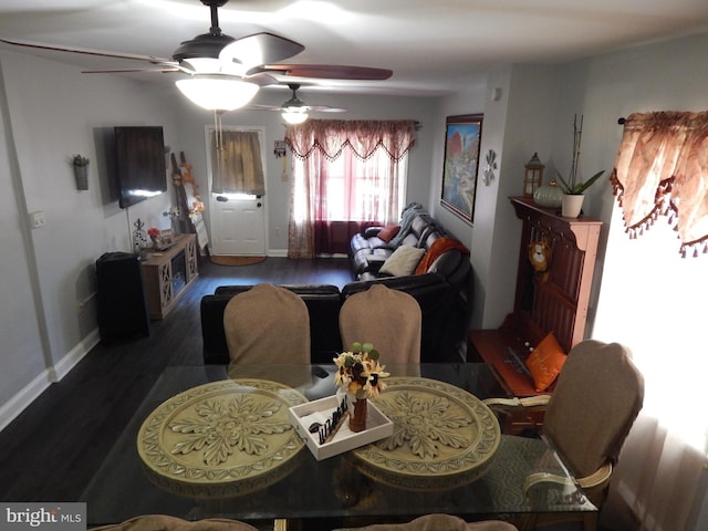 dining space featuring wood finished floors and baseboards