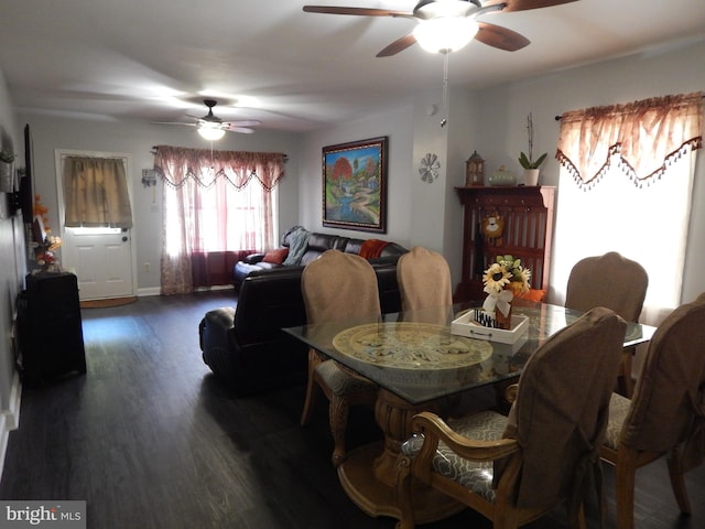 dining space with baseboards, dark wood-style floors, and a ceiling fan