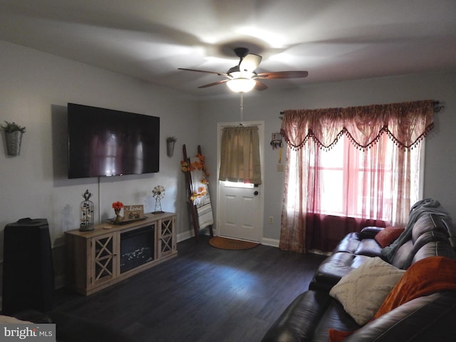 living area with ceiling fan, baseboards, and wood finished floors