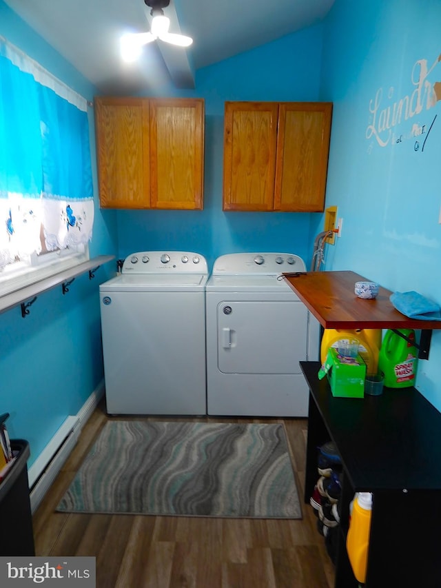 clothes washing area with a ceiling fan, a baseboard heating unit, wood finished floors, cabinet space, and separate washer and dryer