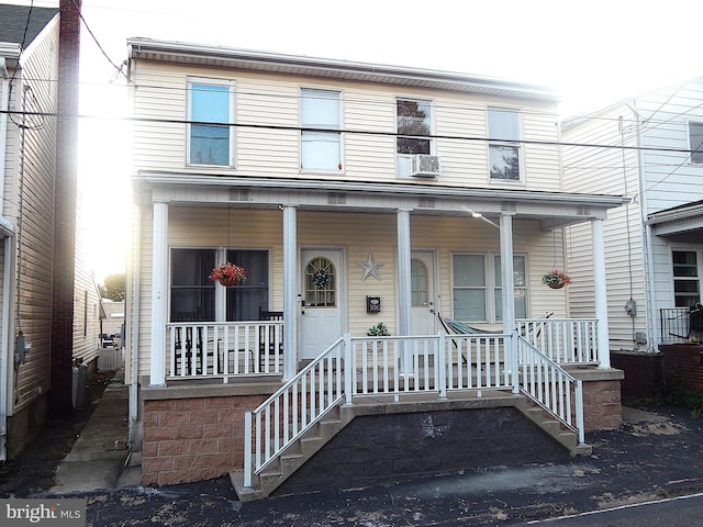 view of front of property with cooling unit and covered porch