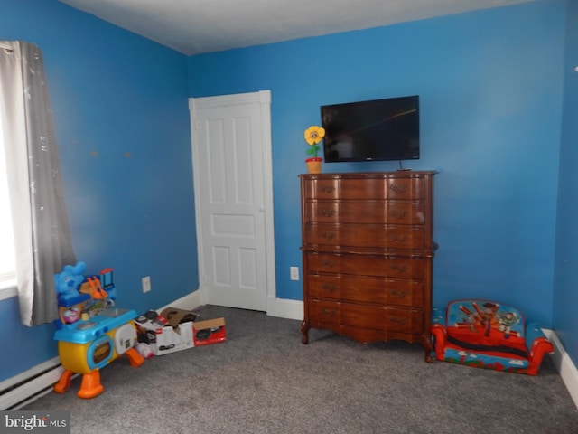 recreation room with carpet flooring, baseboards, and a baseboard radiator