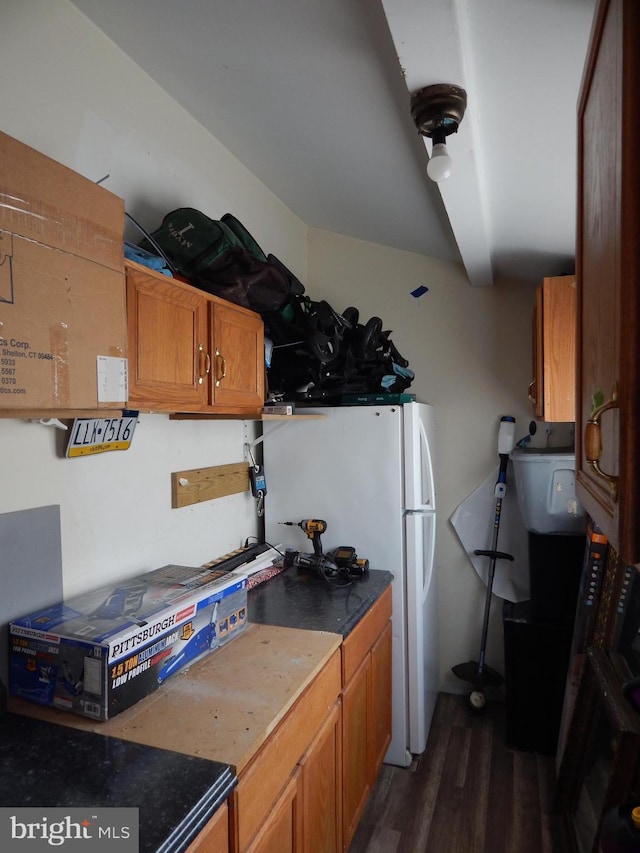 kitchen featuring dark hardwood / wood-style floors and white refrigerator