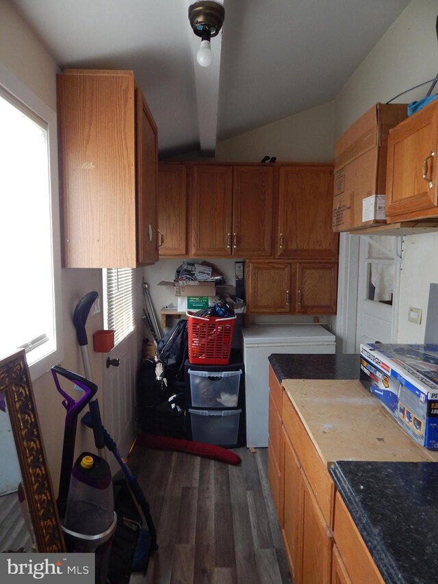 kitchen featuring dark wood finished floors and brown cabinets