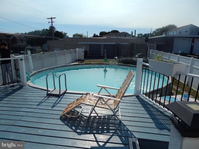 view of swimming pool featuring a deck