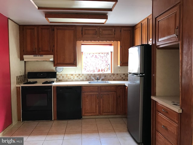 kitchen with dishwasher, white gas range, stainless steel refrigerator, sink, and light tile patterned flooring