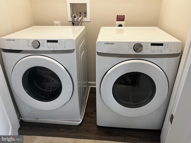 washroom with dark hardwood / wood-style floors and washer and dryer