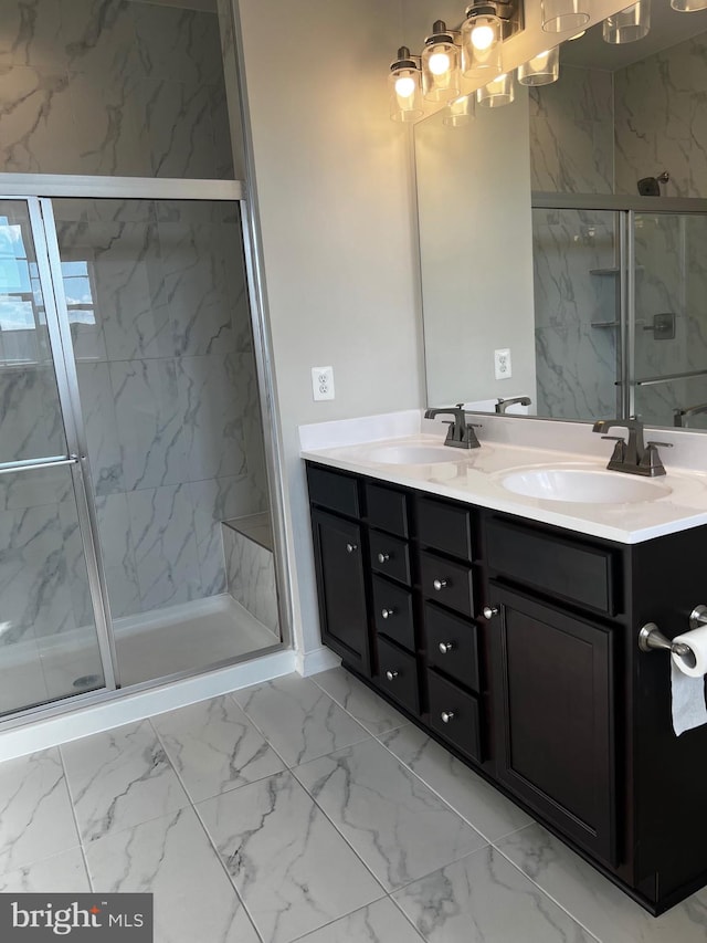 bathroom featuring a shower with door and vanity