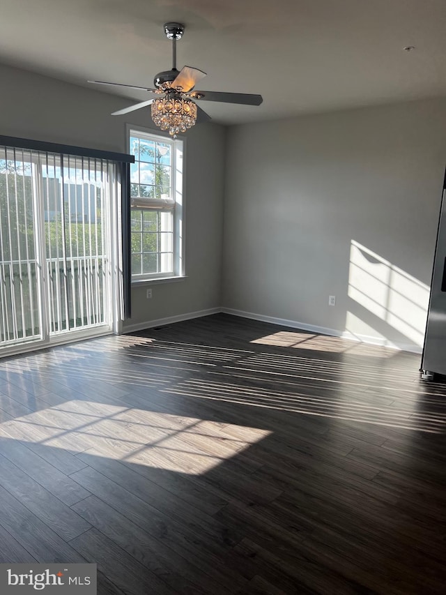 empty room featuring ceiling fan and dark hardwood / wood-style flooring