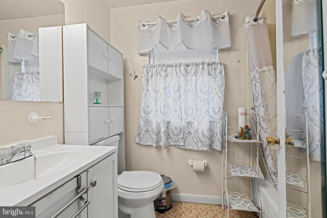 bathroom featuring vanity, toilet, and curtained shower