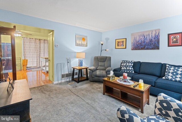 living room with ceiling fan and hardwood / wood-style floors