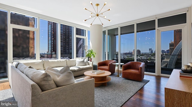 living room featuring dark wood-type flooring, expansive windows, and a chandelier