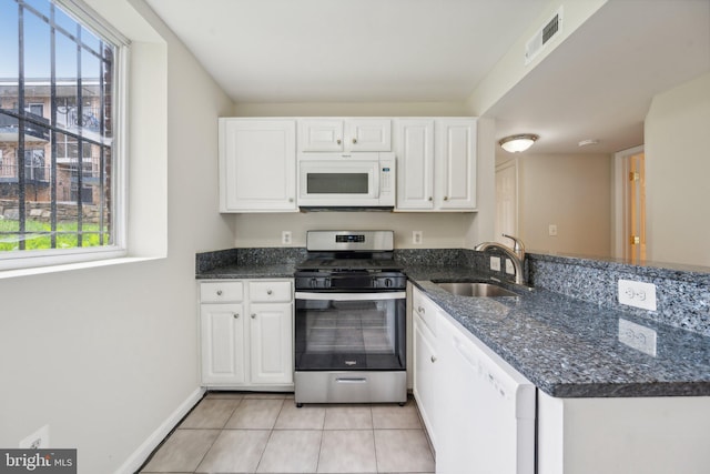 kitchen featuring white appliances, plenty of natural light, white cabinetry, and sink