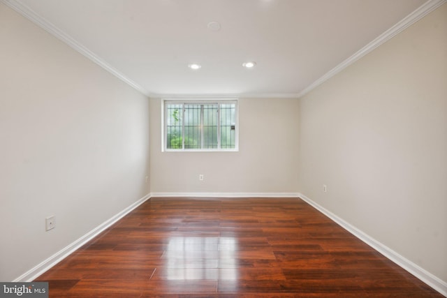 empty room with dark hardwood / wood-style floors and ornamental molding