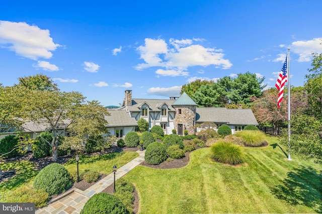 tudor-style house with a front lawn