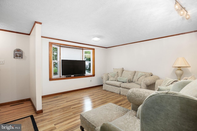 living room featuring a textured ceiling, crown molding, and light hardwood / wood-style floors