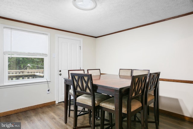 dining area featuring a textured ceiling, dark hardwood / wood-style floors, and ornamental molding