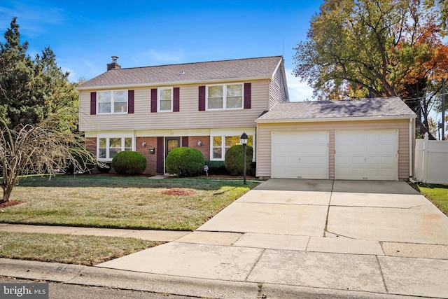 view of front facade with a front yard and a garage