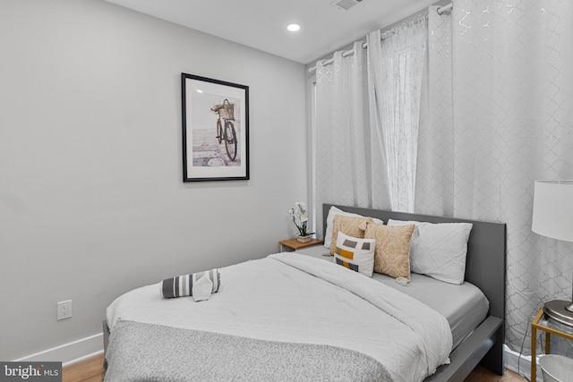 bedroom with hardwood / wood-style floors