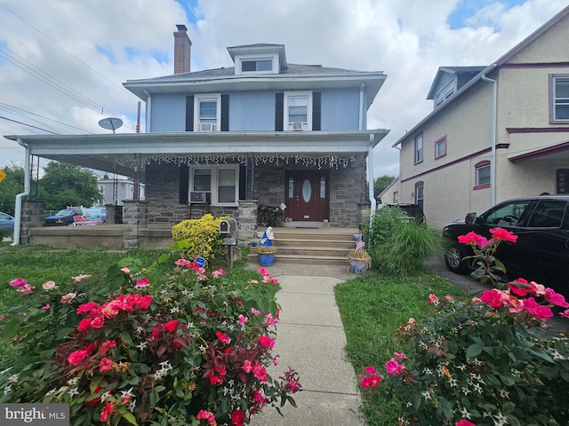 view of front of property with a porch and cooling unit