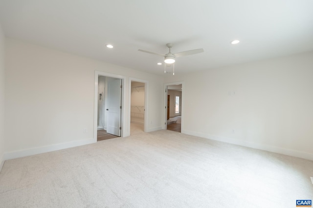 unfurnished room with recessed lighting, light colored carpet, ceiling fan, and baseboards