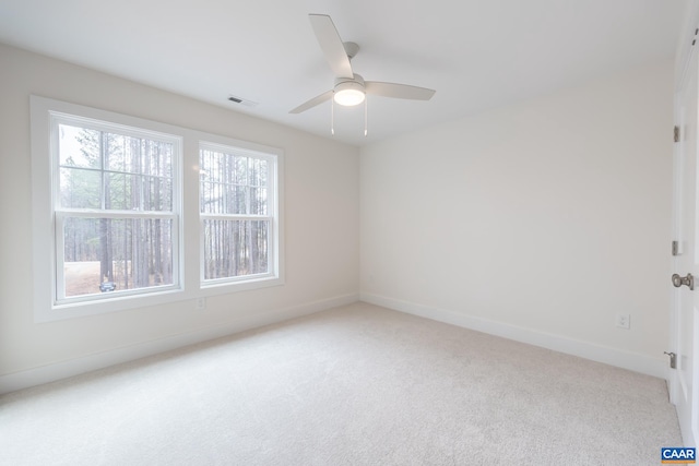 unfurnished room featuring a ceiling fan, baseboards, visible vents, and carpet flooring