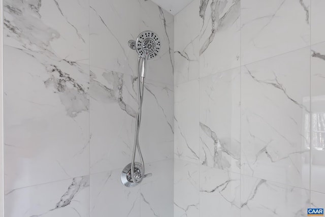 room details featuring a marble finish shower