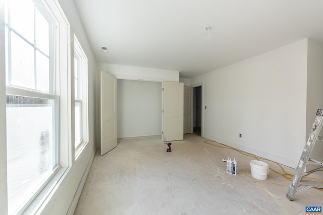 unfurnished room featuring visible vents and baseboards