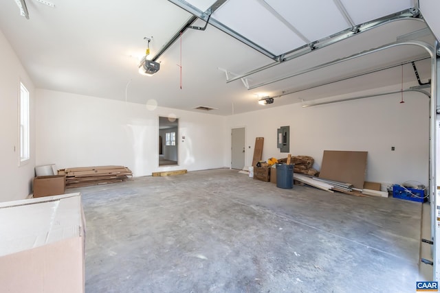 garage with electric panel and a garage door opener