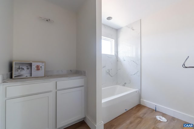 bathroom with wood finished floors and baseboards