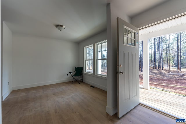 foyer with visible vents, baseboards, and wood finished floors