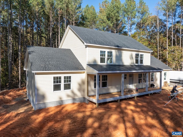 view of front facade featuring roof with shingles