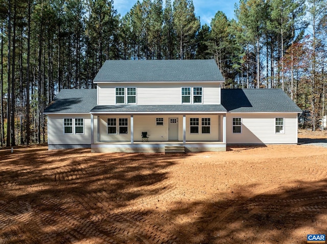 view of front of property with a patio and roof with shingles