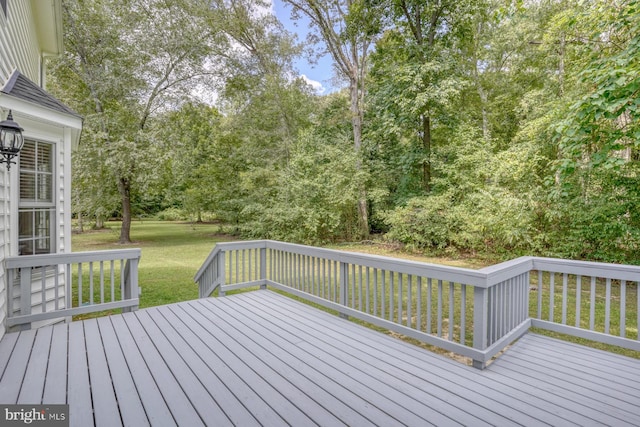 wooden terrace featuring a yard