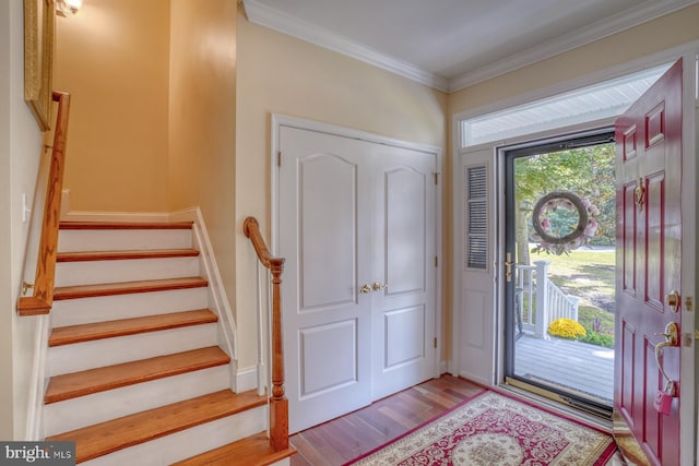 entrance foyer with ornamental molding and light wood-type flooring