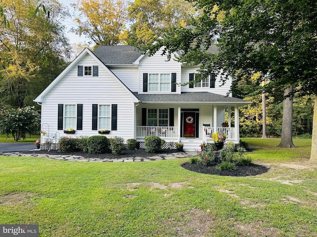 view of front facade featuring covered porch and a front yard