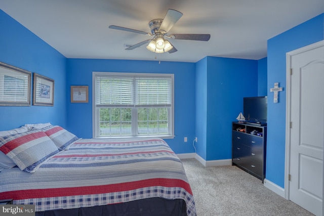 carpeted bedroom featuring baseboards and ceiling fan