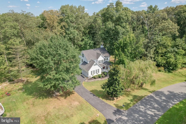 drone / aerial view with a wooded view