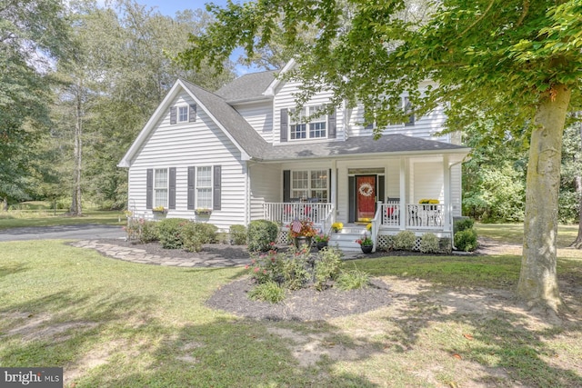 view of front of home with a porch and a front lawn