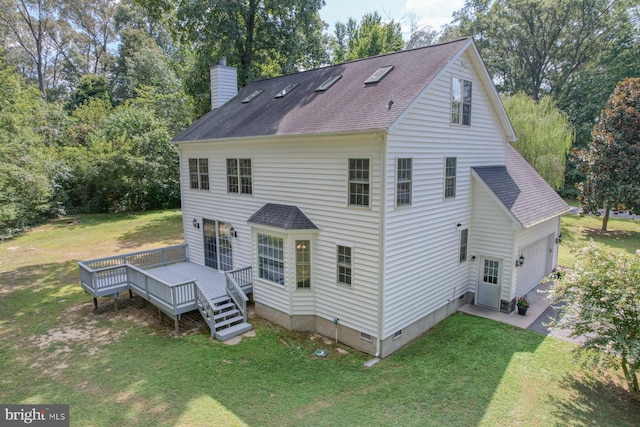 rear view of house featuring a wooden deck, a yard, and a garage