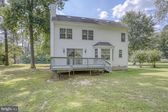 back of property with a wooden deck, a lawn, crawl space, and a chimney