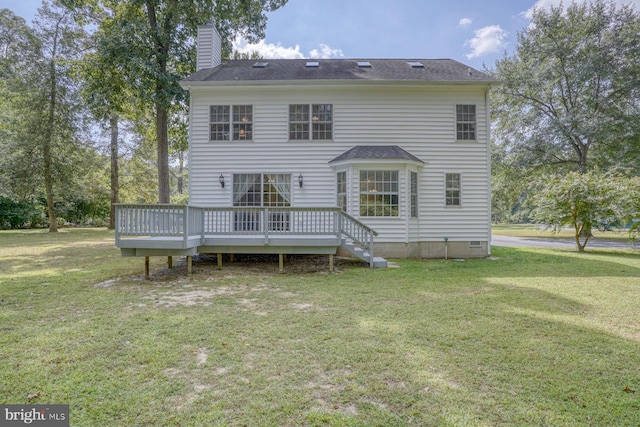 rear view of house with crawl space, a yard, a chimney, and a wooden deck