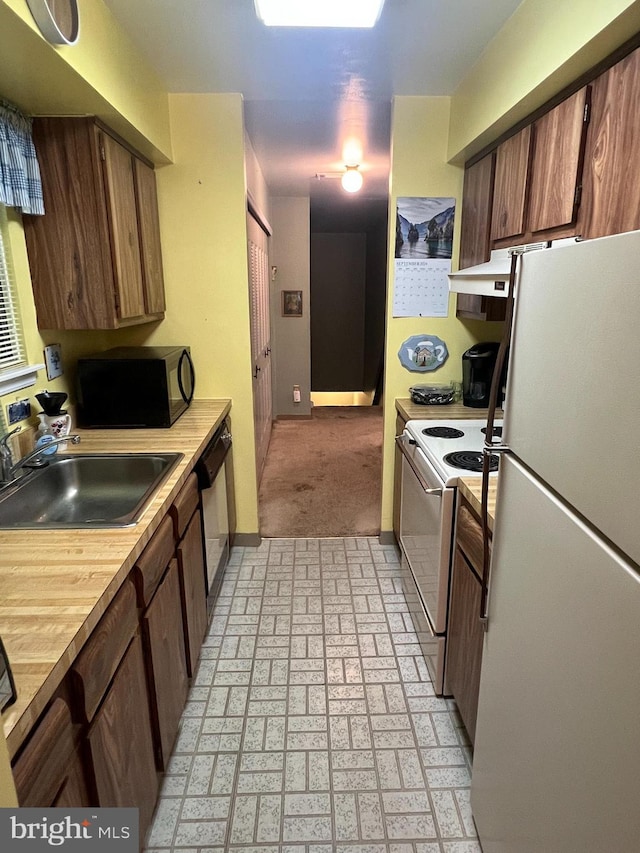 kitchen featuring white appliances and sink